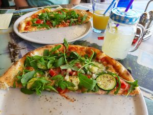 shared vegan pizza for two (each half served on two plats) at Pizzeria Gallus in Bled