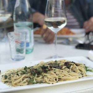 Pasta with truffles and vegan cheese; vegan white wine  at Gaspare Ristorante Pizzeria in Leiden