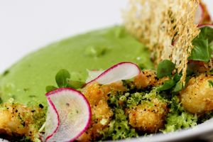 Green Peas and basil Cream, crisp cauliflower, dehydrated black olives, 
radish, green herb soil and Violife cheese crisp  at Veginity in Dublin