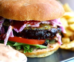 Veginity Big Kahuna Burger with BBQ Sauce, grilled Pineapple, green Apple Slaw, Mesclun and fresh Tomato on a homemade Brioche Bun with triple cooked Chips  at Veginity in Dublin