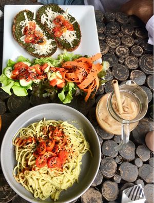 Pesto bruschetta, avocado spaghetti, and iced coffee at Kaya Caffe in Koh Lanta