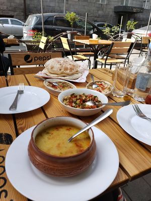Lentil soup, Armenian salad, hummus, aubergine dip and bread at Zatar Pizza in Yerevan