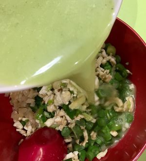 Pouring the tea broth into the rice bowl at Traditional Hakka Rice 河婆客家擂茶 in Central Singapore