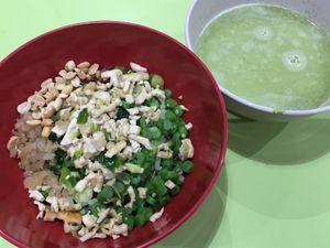 Brown rice covered with 6 chopped / diced toppings: pickled radish, bok choy, cabbage, peanuts, firm tofu, long beans. Green tea broth by the side. Mix together and enjoy! $3.5 for the regular serving with white rice. $4 for brown rice (actually, a mixture of brown and white rice).  at Traditional Hakka Rice 河婆客家擂茶 in Central Singapore