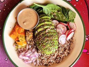 K’S BOWL - mixed quinoa, grilled aubergine, spinach, grated radish and onion, marinated shaved carrot & courgette, avocado, mixed seeds and a Tahini dressing at Project Social in Ibiza