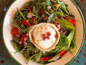 GOATS CHEESE SALAD - spinach, rocket, cherry tomatoes, red onion, pomegranate, walnuts, red pepper and goats cheese with an orange and agave balsamic dressing. at Project Social in Ibiza