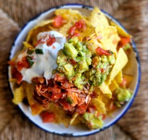 Vegan Nachos with vegan cheddar, guacamole, tomato salsa, vegan yoghurt and jalapenos, add BBQ pulled Jackfruit at Project Social in Ibiza