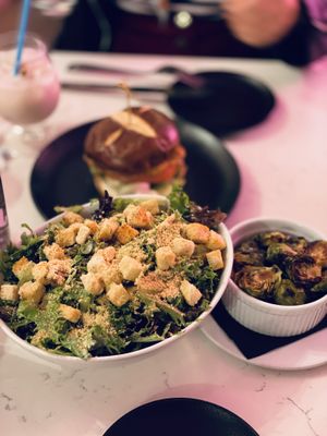 Caesar salad, brussels sprouts, and thai chicken burger at P.S. Kitchen in New York City