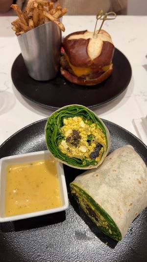 Breakfast burrito, burger, truffle fries  at P.S. Kitchen in New York City