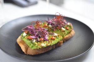 Avocado Toast! Soft garlic puree, harissa chili puree, cilantro and lime zest at P.S. Kitchen in New York City