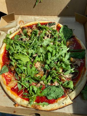 pizza with classic sauce, vegan cheese, arugala, spinach, roasted garlic, mushrooms, oregano at Blaze Pizza in Monroeville