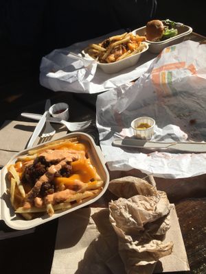 Fries with vegan cheese and burgers that were already devoured  at Plant Power Fast Food - Encinitas in Encinitas