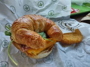 Croissant, egg, cheese, bacon at Plant Power Fast Food - Encinitas in Encinitas