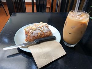 Chocolate almond croissant $7 and almond ice latte $7 at Gathered Kitchen in Glebe