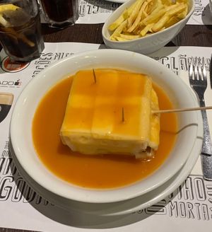 Lovely francesinha with vegan cheese, vegan tofu, vegan sausage, and a vegan alcohol gravy  at Lado B Cafe in Porto