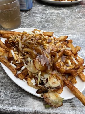 Vegan Poutine with fried onions at La Banquise in Montreal
