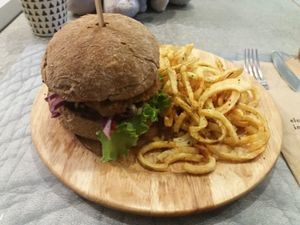 Seitan burger and curly fries at Elephant in the Room in Thessaloniki