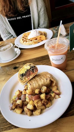 breakfast burrito and peach belgium waffles  at Pulse Cafe in Hadley