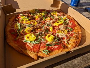 Large thick crust with light vegan cheese, beyond crumbles, banana peppers, roasted garlic and basil at Oath Pizza in Nantucket