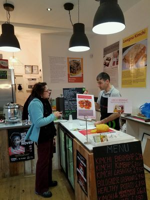 Mauro , owner offering a sample of his homemade Nutella. at Vegan Yes in East London