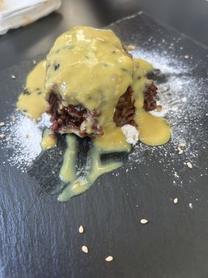 Chocolate onigiri covered in delicious orangy sauce   at Vegan Yes in East London