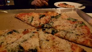 Spinach & onion pizza with vegan cheese at Need Pizza in Cedar Rapids