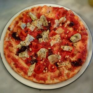 Classic base with artichoke, caramelised onion, pine kernels, sweet pepperdew peppers and garlic oil at Pizza Express in Cheltenham