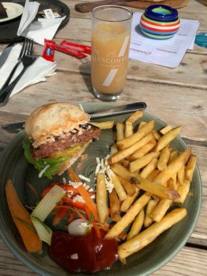 Vegan ciabatta burger with fries and an apple drink  at Cantina in Paignton