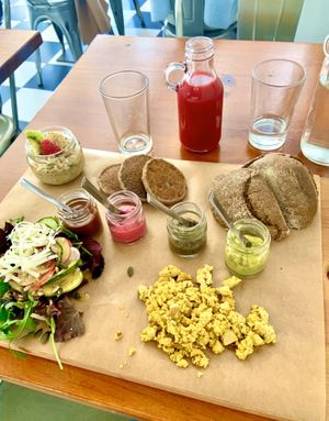 Brunch of champions! One meal = Tofu scramble, warm bread with avocado spread, pancakes and chocolate sauce, chia banana pudding, Side salad 🥗, beet juice mixture & a coffee! at GiG - Green is Good in Ericeira