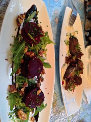 Beet feta towers and smoked King oysters on the other dish at Atlas Bar in Copenhagen