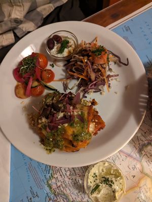 Lasagna with side salads at Atlas Bar in Copenhagen