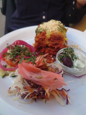 Lasagne with cashew cheese, tomato salad, råkost and thatziki at Atlas Bar in Copenhagen