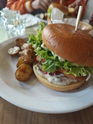 Fish burger with roasted potatoes. at Atlas Bar in Copenhagen