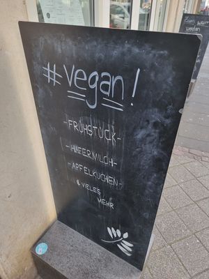 vegan mentioned on street sign at Café Heimisch in Cologne