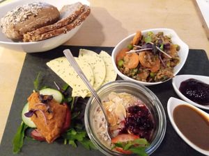 vegan breakfast plate ("cheeze", jam, mustard sauce, lentil salad, lentil spread, overnight oats, veggies, bread) at Café Heimisch in Cologne