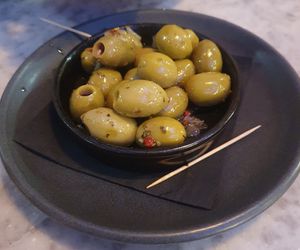 Marinated Green Olives: with pink peppercorns and whole sweet garlic cloves at Pizza Express - Trafford Centre in Manchester