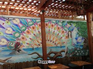 A beautiful perspective of our mural, created by Reese Sutfin and Terri Lambert, in a photo by T.A. Roth. This is what greets our patrons, accompanied by the sounds of a babbling brook (via fountains) when they dine on our deck.  at Fudenjuce in Nevada City