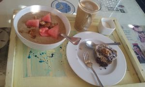 Banana smoothie bowl, almond latte and raw brownie. at Marine Garden Camp in Dahab