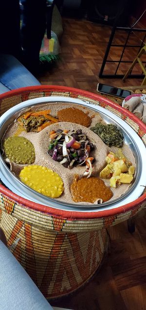 Vegan beef tibs with veggie platter around it at Ghion Cultural Hall in Atlanta