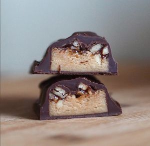 Homemade bars daily. Seen here is our Vegan Pecantastic. Soft cashew base, sugar-free salted caramel pecans and luxurious dark chocolate coat. at The Muscle Bakery in 