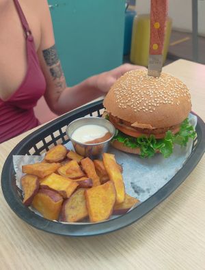 Chicken burger with sweet potato wedges and dip at Huacamole Vegan Food in San Pedro