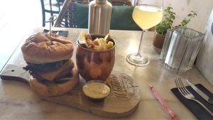 Delicious vegan bbq burger with fries and a kombucha drink. at Mr. & Mrs. Watson in Amsterdam