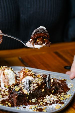 Chocolate Oreo Brownie with pistachios, vegan vanilla ice cream and hot chocolate sauce  at Small Print Pizza Bar in Windsor
