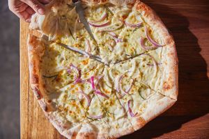 Potato pizza with red onion, gremolata, vegan mozzarella, vegan fior di latte and rosemary  at Small Print Pizza Bar in Windsor