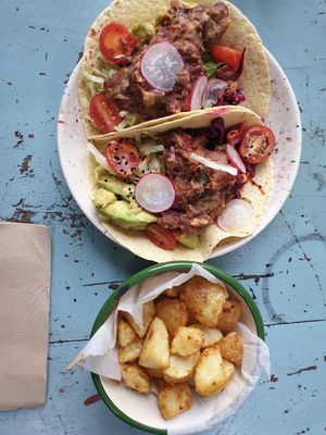 Refried bean taco with fried potatoes. The mint in taco made it great. at Loves Cafe in Weston-super-mare