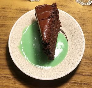 Chocolate fudge cake with mint custard - vegan junk food night  at Loves Cafe in Weston-super-mare