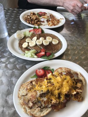 Too: classic tofu scramble with home fries, blueberry pancakes (butter NOT vegan so didn’t add), and bottom: Vegan melt with cheeze and home-fries on bagel.  at Stella's Cafe in Wildwood