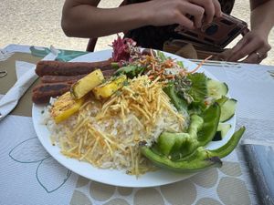 Homemade chorizo style seitan sausages with grilled pineapple, rice and salad at Veggie Momi in Albufeira