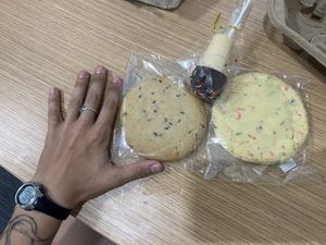 Big cookies (hand for size reference) and a cake pop, but dry  at On The Bus in Milwaukee