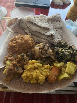 Veggie sampler, mushroom tibs, and shuro with teff injera  at Moya in San Francisco